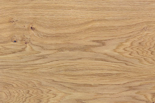Light natural wood texture. The board have a strong clear texture of wood with knots. A wood grain pattern featuring even grains of wood running vertically across the image.