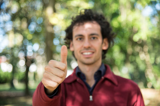 istock smiling man making ok sign and wink 1214749990