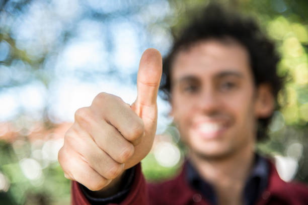 istock smiling man making ok sign and wink 1214750181