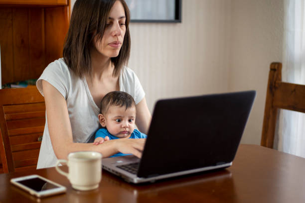 istock woman working from home with children 1214750347
