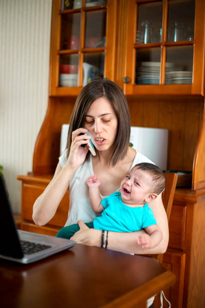 istock woman working from home with children 1214750537