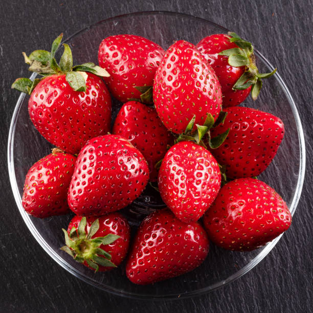 istock red strawberries on a black background, lies on a graphite board 1214750809