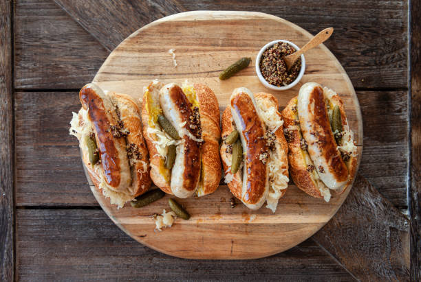 Delicious hot dogs with sauerkraut Delicious pork sausage hot dogs with sauerkraut and mustard german food photos stock pictures, royalty-free photos & images