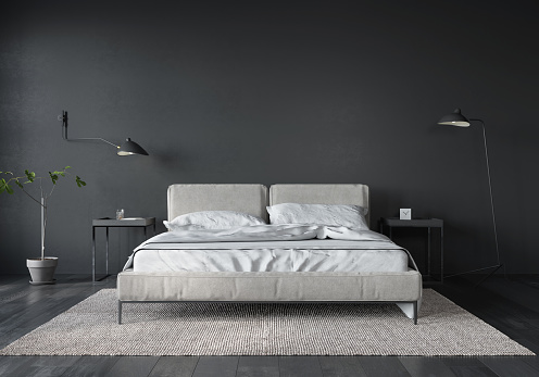 Interior del dormitorio con cama blanca y pared gris oscuro photo