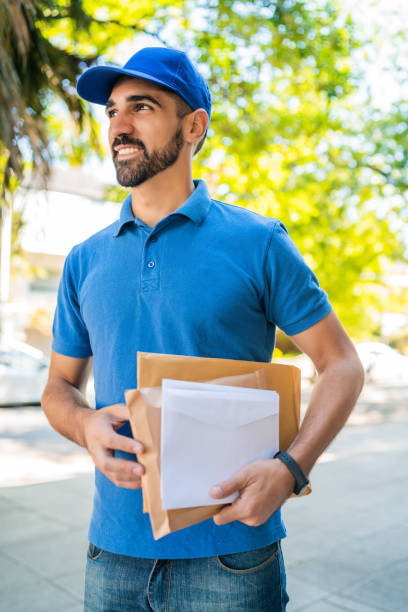 istock Postman carrying packages and letters. 1214753795