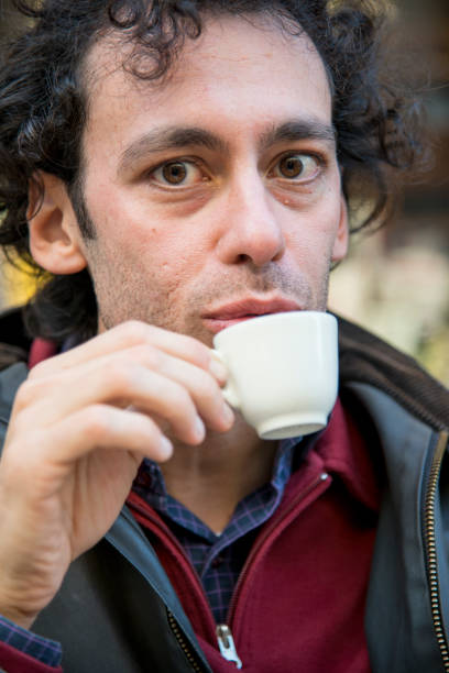 istock a smiling man drinking a coffee in a open air bar 1214753860