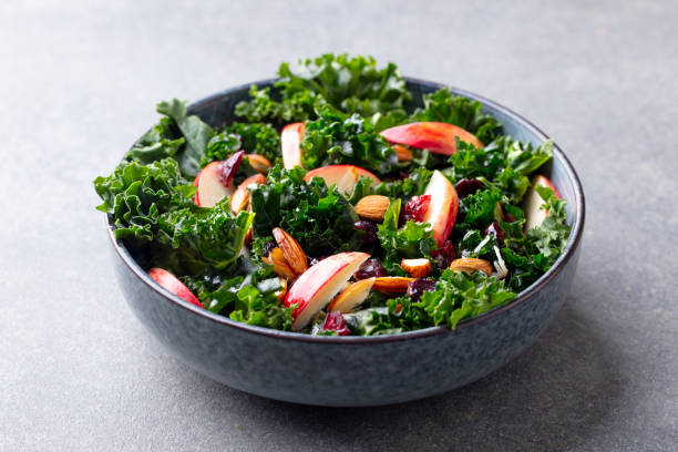 istock Kale salad with apples and nuts. Grey background. Close up. 1214756238