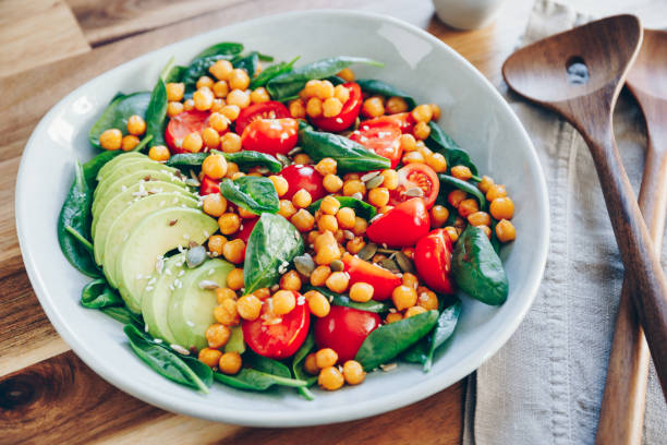 istock Fresh healthy salad with chickpea, avocado, cherry tomatoes and spinach. 1214756285