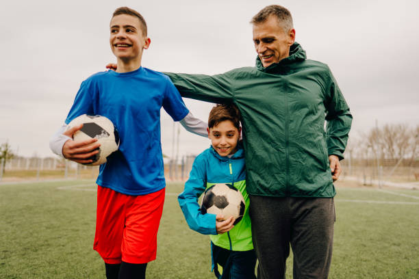istock Grandfather and grandsons on a soccer field 1214756768