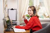 Distance Learning. Girls studying at home using laptop during coronavirus pandemic