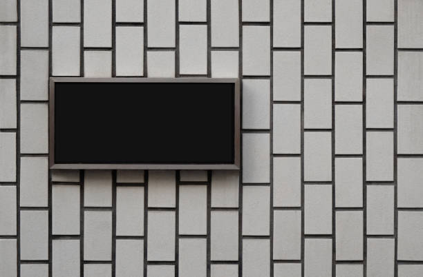 istock Black blank signage board on vintage wall texture 1214757818
