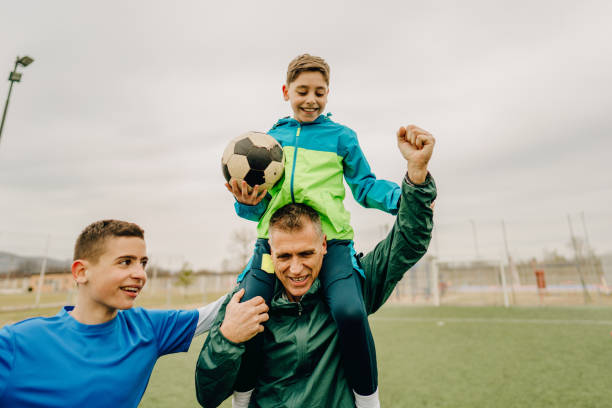 istock Grandfather and grandsons on a soccer field 1214758001