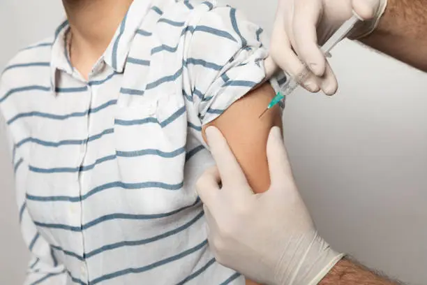 Young women receiving coronavirus vaccine