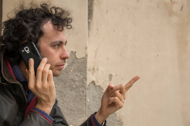istock a threatening man at phone in open air 1214758040