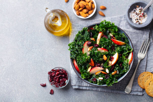 istock Kale salad with apples and nuts. Grey background. Copy space. Top view. 1214758136