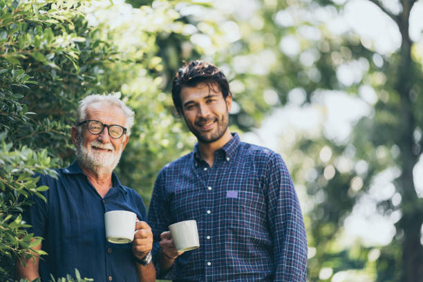istock Old father and son, Morning coffee in a garden 1214758171