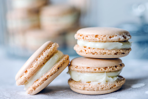 Homemade macarons pastries with custard on the table - close upHomemade macarons pastries with custard on the table - close up