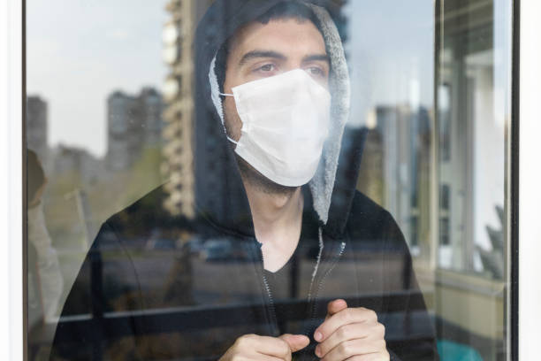 istock Young men isolated himself wearing a face mask quarantine himself 1214759288