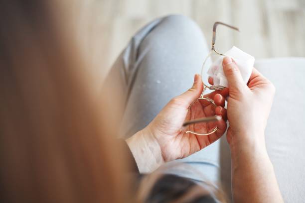 istock Hand wiping glasses with disinfectant wipes 1214759722