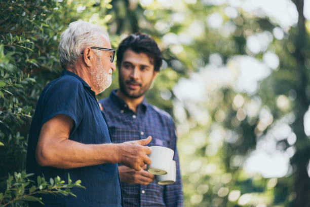 istock Old father and son, Morning coffee in a garden 1214759932