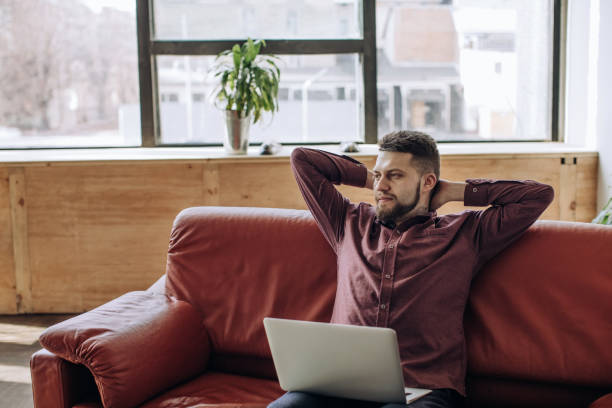istock Young man working remotely at home 1214760661