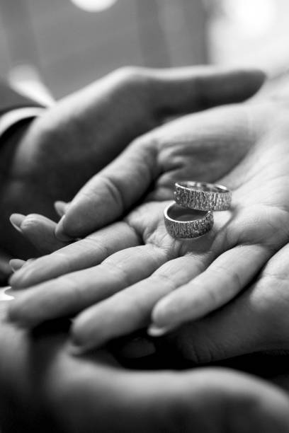 istock groom puts bride on wedding ring 1214760828