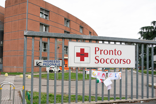 This is a collection of pictures taken in Milan, Italy, on March 2020 during the first days of Corona Virus crisis: empty city, police doing control, people queuing for grocery shopping, hospitals, stations and point of interest of the city.\n\nIn this picture entrance of the emergency in the hospital.