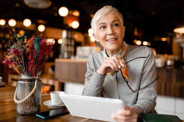 istock Senior woman sitting in a cafe 1214761518