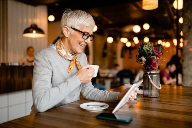 istock Senior woman sitting in a cafe 1214761526
