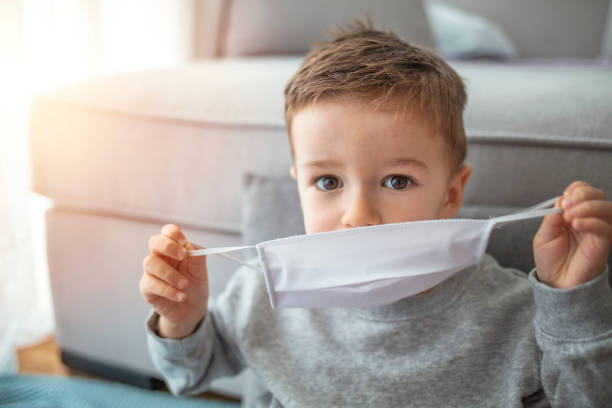 istock Young child wearing a respiratory mask as a prevention 1214761545