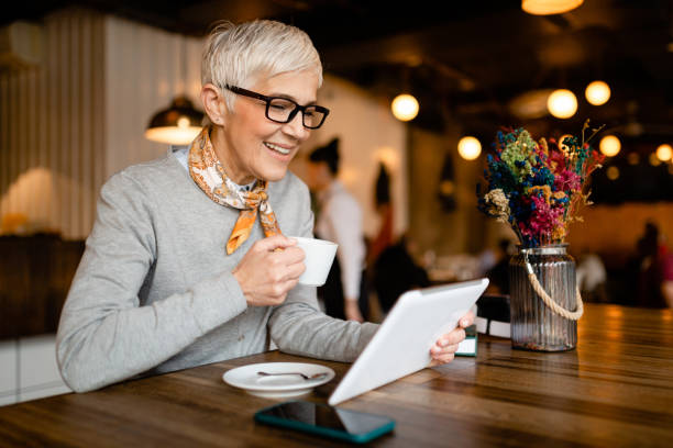 istock Senior woman sitting in a cafe 1214762164