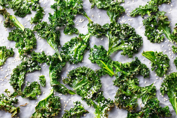 istock Kale chips, healthy snack on parchment paper. Top view. 1214762792