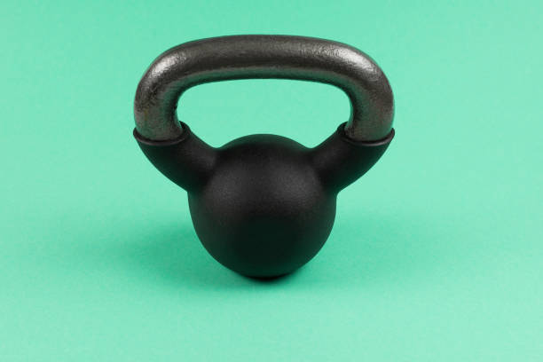 istock Black weight on green background. 4 kg weight. 1214762806