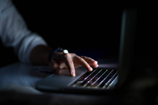 istock Close up of hands typing on laptop. Night work concept. 1214763165