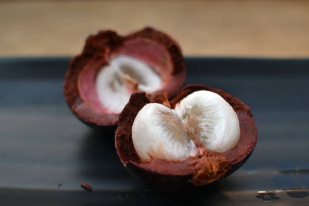 istock mangostin in a black plate 1214763312