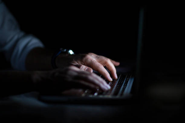 istock Close up of hands typing on laptop. Night work concept. 1214763363