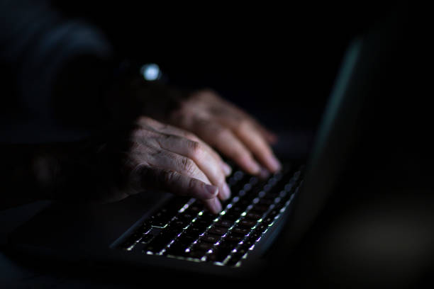 istock Close up of hands typing on laptop. Night work concept. 1214764044