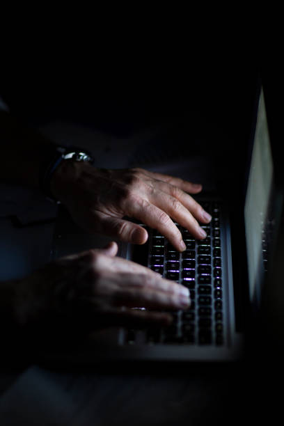 istock Close up of hands typing on laptop. Night work concept. 1214764045