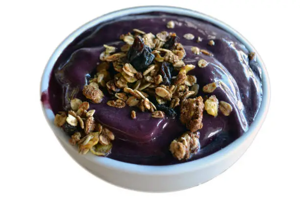 Açaí bowl with cereals in white background. Tipical food in Brazil