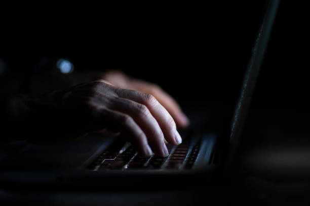 istock Close up of hands typing on laptop. Night work concept. 1214764319