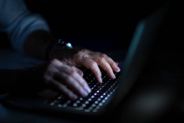 istock Close up of hands typing on laptop. Night work concept. 1214764320