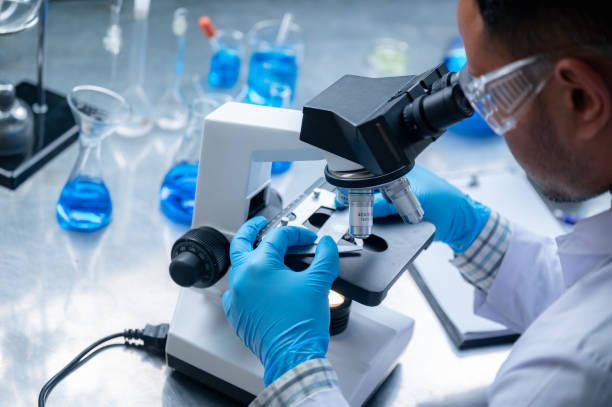 istock Science and medicine, scientist analyzing and dropping a sample into a glassware, experiments containing chemical liquid in laboratory on glassware, DNA structure, innovative and technology. 1214764427