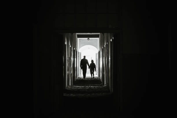 istock couple holding hands and walking into light together 1214765832