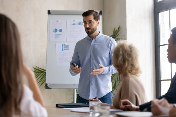 istock Male Caucasian speaker make whiteboard presentation at office 1214766086