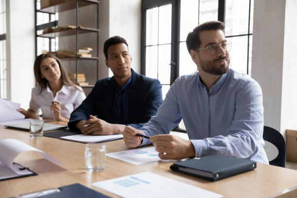 istock Multiracial businesspeople listen to office presentation or training 1214766089