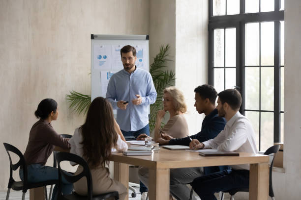 istock Male speaker present project on whiteboard at meeting 1214766099