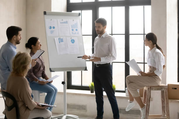 istock Young businessman make flip chart presentation at office briefing 1214766151