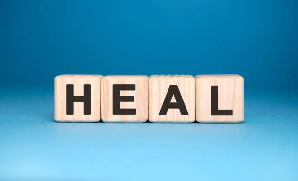 istock HEAL - text on wooden blocks, medical concept, blue background 1214766201