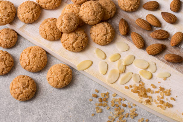 italienische amaretti kekse. knusprige mandelkekse mit in scheiben geschnittenen und ganzen nüssen und großen kristallen aus braunem zucker. - biscotti stock-fotos und bilder