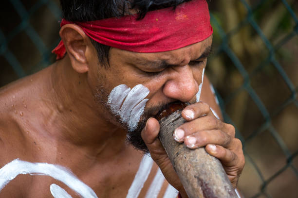 Australia: Didgeridoo An Aboriginal man plays the traditional didgeridoo in Kuranda. didgeridoo stock pictures, royalty-free photos & images